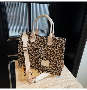Detail of leopard print tote bag featuring canvas handles and a Jingpin leather label