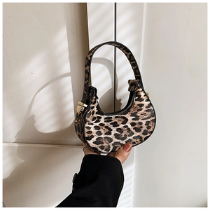 Close-up of leopard print crescent bag with black leather trim and gold hardware details