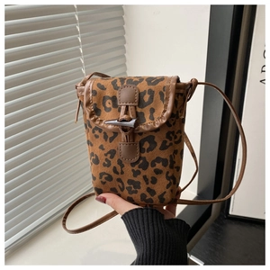 Close-up of leopard print crossbody phone bag with horn toggle closure and leather trim