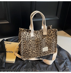 Detail of leopard print canvas tote bag with front pockets and sturdy woven straps