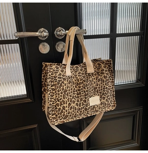 Detail of leopard print tote bag with dual front pockets and adjustable shoulder strap