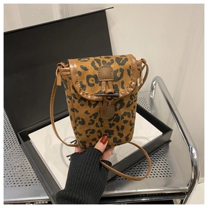 Detail of leopard print crossbody phone bag with horn toggle closure and brown strap