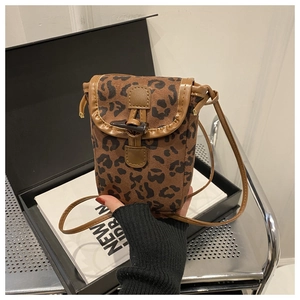 Detail of leopard print phone bag featuring suede texture and vintage horn buckle closure