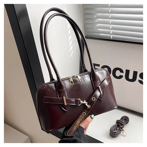 Detail of dark brown shell bag with fashion embossing and metal buckle decoration