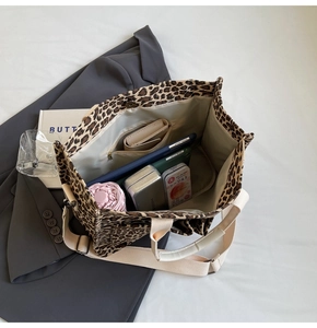 Interior detail of leopard print tote bag showing large capacity and internal zipper pocket