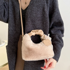 Chic khaki plush handbag with faux fur texture and leather handle shown on a model