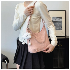 Detail of light pink casual shoulder bag with white cloud plush charm and silver chain strap