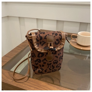 Detailed view of leopard print crossbody phone bag with horn buckle and leather strap