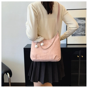 Macro view of pink soft PU leather tote bag with silver chain and cute cloud charm