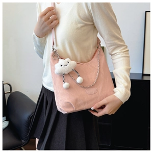 Detailed shot of pink nylon crossbody bag with metal chain and cute cloud charm