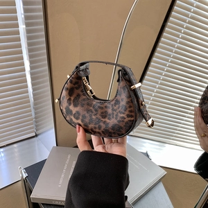 Trendy leopard print crescent hobo bag with gold hardware and chic mini handle