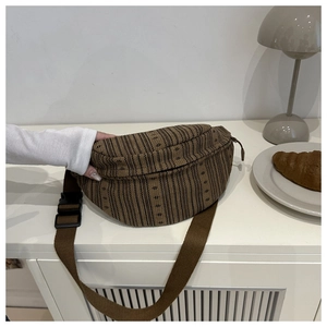 Detail of vintage brown striped corduroy waist bag with metal zipper and durable buckle