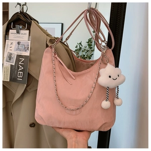 Detail of pink crescent moon Hobo bag with plush cloud charm and silver chain strap