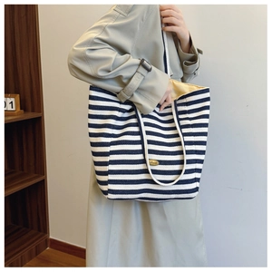 Detail of blue and white striped canvas tote bag with Handmade label and inner lining