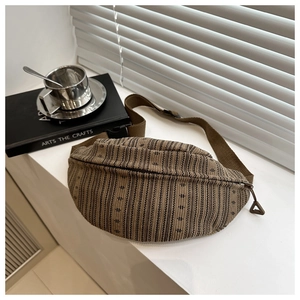 Detailed macro view of retro woven fabric texture and black buckle on brown waist bag