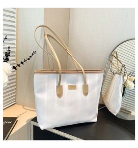 Detail of the large white canvas tote bag with JINGPIN label and brown leather strap