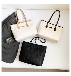 Detailed view of large pleated tote bags in black, white, and beige for commuting