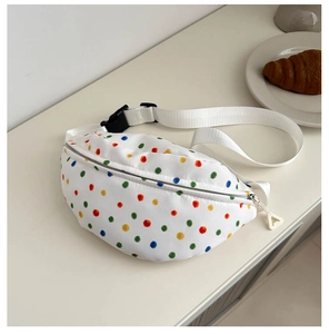 Detailed top view of white canvas crossbody bag with colorful polka dots and nylon strap