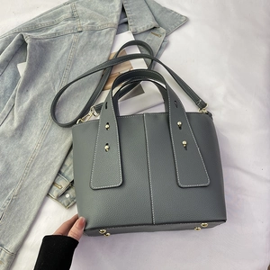 Gray lychee grain leather handbag with contrast stitching and metal rivet details