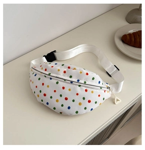 Detailed top view of white crossbody bag with colorful polka dots and canvas texture