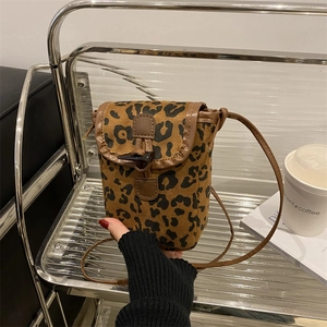 Fashionable leopard print crossbody phone bag with brown trim and toggle button closure