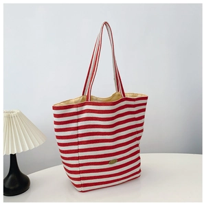Detail view of the red and white striped canvas tote bag showing the wide opening and lining