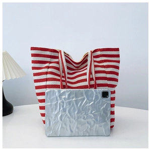 Canvas tote bag in red and white stripes showing large capacity with a tablet