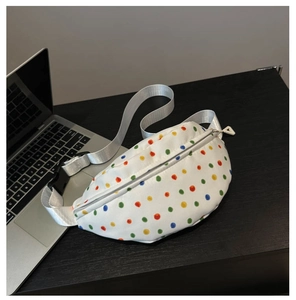 Detail of white floral fanny pack with colorful polka dots and gray woven strap