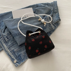 Minimalist black corduroy bucket bag with strawberry print and rope shoulder strap