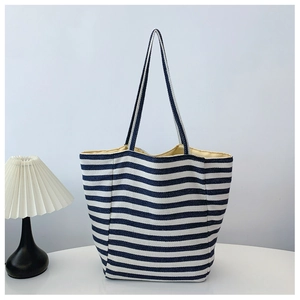 Stylish navy blue and white striped canvas tote bag for women in a cozy home setting