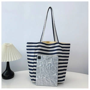Detail of blue and white striped canvas tote bag showing large capacity and soft texture