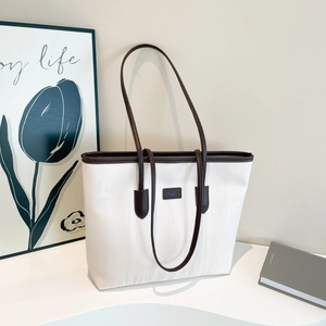 White large capacity tote bag with dark brown leather trim and striped texture design