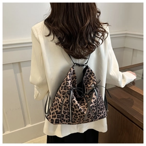 Rear view of leopard print backpack showing soft texture and decorative ribbon bow detail