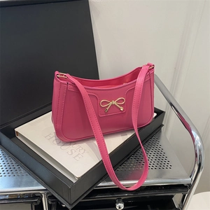 Fashionable rose red shoulder bag with golden bow decoration and PU leather finish
