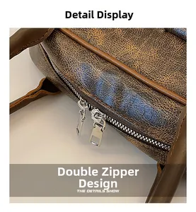 Detail view of the vintage dark brown leather bag showing the functional dual silver zippers