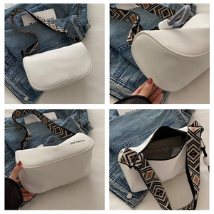 Detail of white half-moon crossbody bag with wide geometric jacquard woven strap