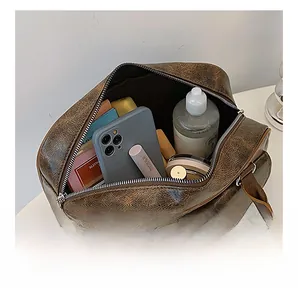 Internal view showing large storage capacity for phone and cosmetics in vintage brown bag