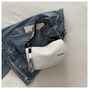 White leather crossbody bag with geometric wide strap and blue knotted charm detail