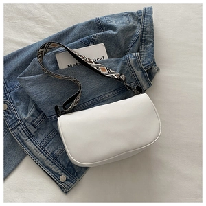 Close-up of white waterproof crossbody bag with geometric pattern wide shoulder strap