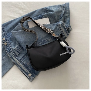 Detail of black nylon crescent bag with patterned wide strap and OOTMAO logo detail