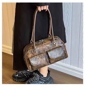 Detail of vintage brown PU leather tote bag featuring two front magnetic flap pockets