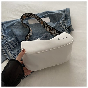 Detail view of white waterproof dumpling bag with ethnic geometric wide strap and logo