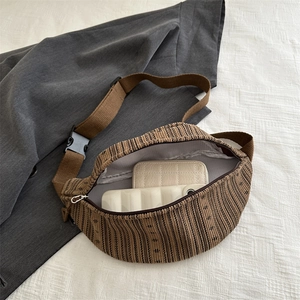 Brown corduroy crossbody chest bag with adjustable strap and large interior capacity