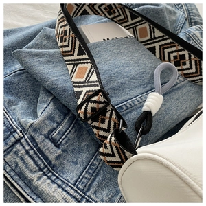 Detail of adjustable geometric woven strap with ethnic pattern on high-density fabric