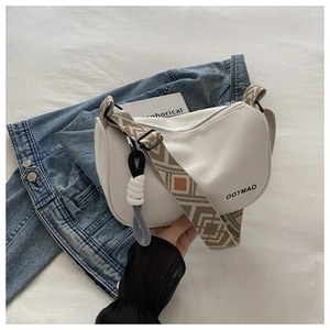 White crescent crossbody bag detail with ethnic geometric pattern wide woven strap