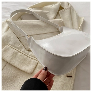 Detailed shot of white patent leather hobo bag with sleek finish and gold hardware accents
