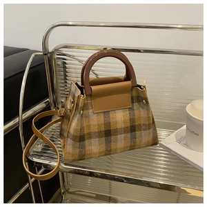 Close-up of retro plaid handbag with brown resin handles and textured wool fabric