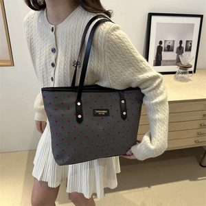 Gray canvas tote bag with red star pattern and black handles for daily commuting
