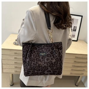 Chic leopard print tote bag with black leather straps and gold chain accents
