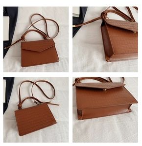 Details zur braunen Krokodil-Handtasche mit Knotengriff und feiner Leder-Prägung
